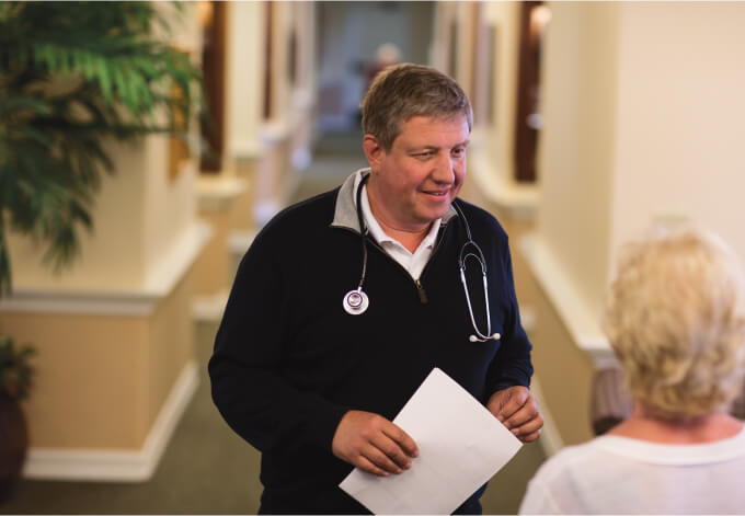 Male Staff member speaking to a patient